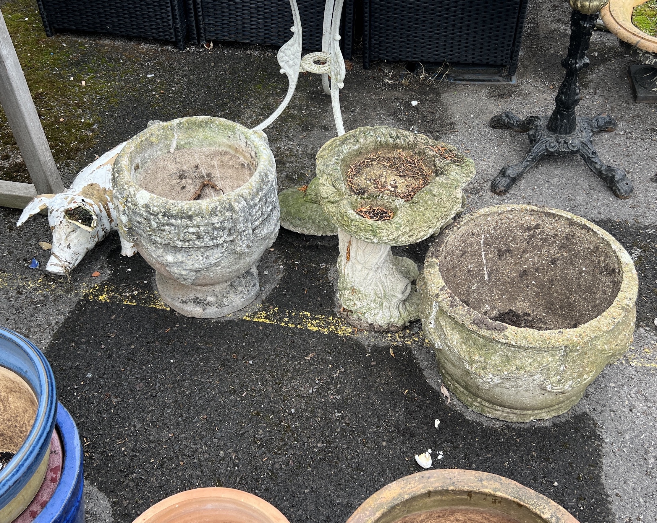 Two reconstituted stone garden planters, larger diameter 40cm, height 30cm, two bird baths and two ornaments